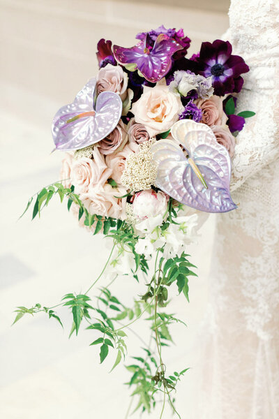 Bridal bouquet with blush roses and purple anthuriums