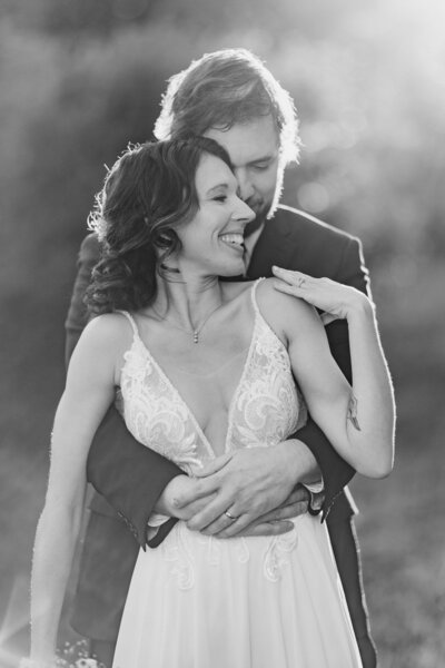 Newlyweds hold eachother while sharing a private moment