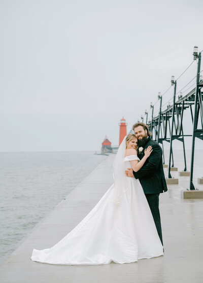 a bride and groom on the pier in Grand Haven