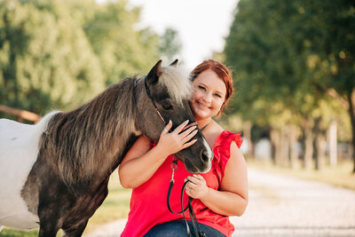 grey horse with woman in red dress