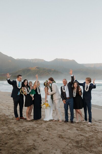 bridge and groom kissing in Kauai on beach at hanalei bay