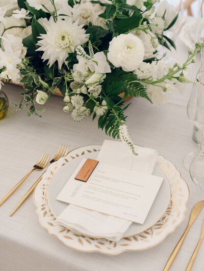 a custom wedding signage design  seating chart with white flowers and babys breath at a luxury alyssa amez design wedding
