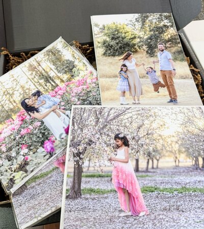 Collection of printed photography samples from various sessions displayed for client reference during design consultation