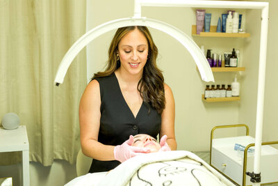 Cindy looking down at client during facial