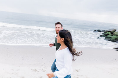couple running along the water in Cape May beach