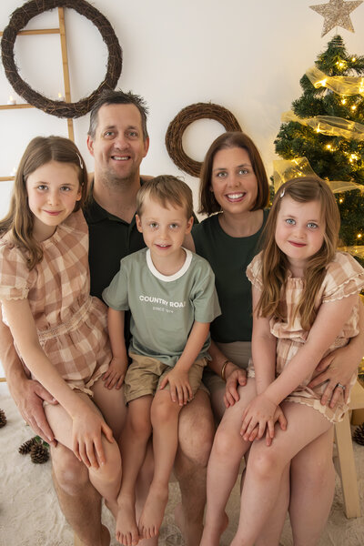 Family Christmas photography session in Melbourne studio with festive decorations
