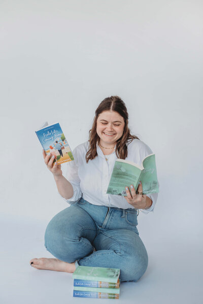 Woman holding copies of books