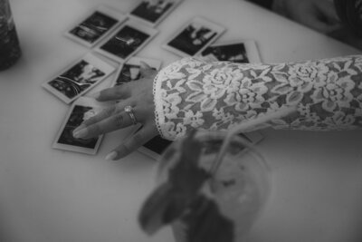 A detail photo of brides hand with Polaroid photos from their Las Vegas Elopement. 