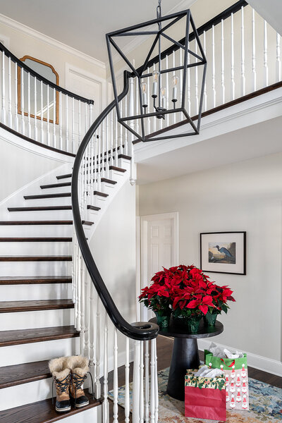 white winding staircase with wood steps and black railing