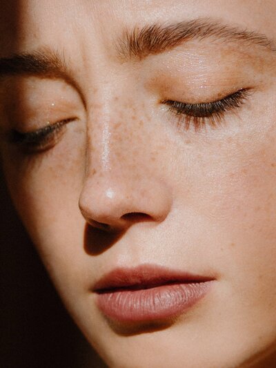 women up close with brown eyebrows