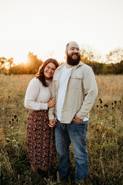 Photo of Wife and Husband in a field taken by Duluth wedding photographer, Kelly Friday Photography. 