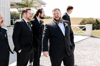 Black and white image of groomsmen hanging out together