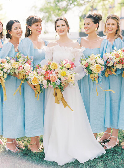 Bride and bridesmaids in blue dresses at wedding planned by Bianca Nichole and Co
