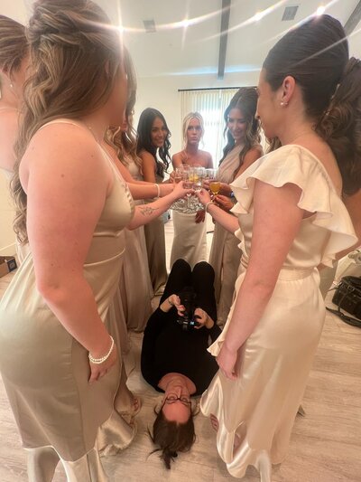 Spring Creek Photo lays on ground shooting upwards to capture a celebratory photo at The Arlo