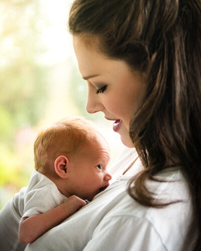 Heart warming photograph of mother and baby lying on her chest, a moment of love and connection