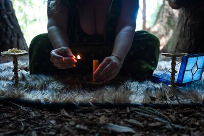A close up shot of Rachael Maddox's hands, Oracle Business Witch, as she prepares to perfrom a sacred ceremony outside as part of her sales page writing ritual.