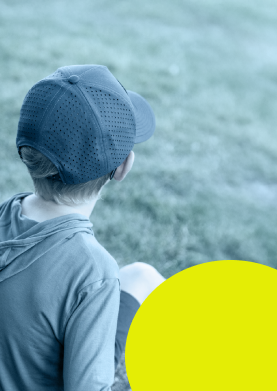 child wearing baseball cap watching pickleball