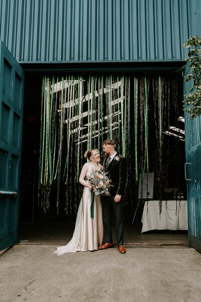 Wedding ceremony with  mismatched chairs at peddler warehouse