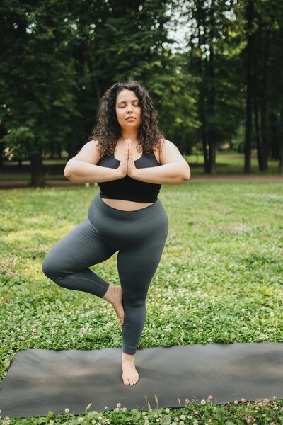 Woman doing online yoga in an outdoor area.