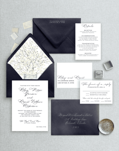 Flat lay of a navy blue wedding invitation suite
