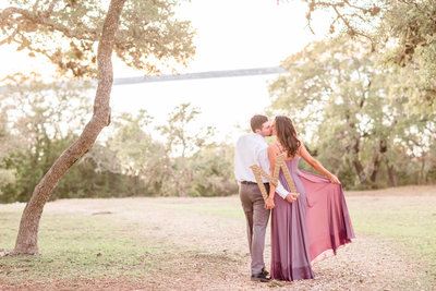 engagement photo lakeside with a purple dress and a gold monogram letter