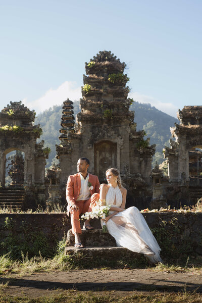 bride and groom walk along the beach at sunset in Bali