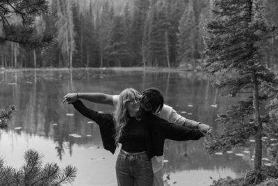 Couple playing in the mountains candidly for their adventurous Rocky Mountain engagement session