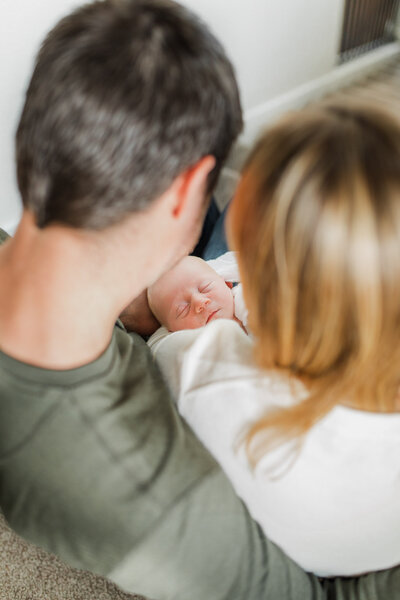 Parents looking down lovingly at their newborn baby