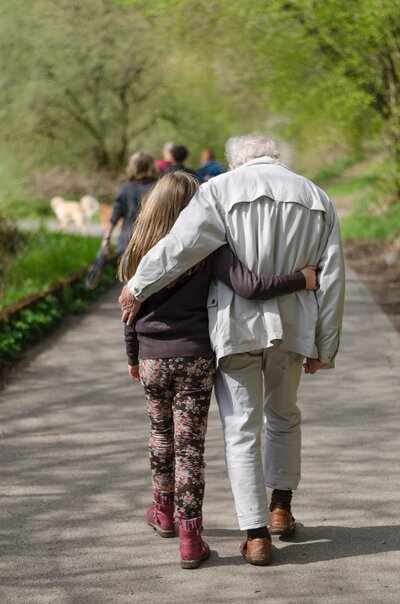 Grandpa enjoying a walk with his granddaughter