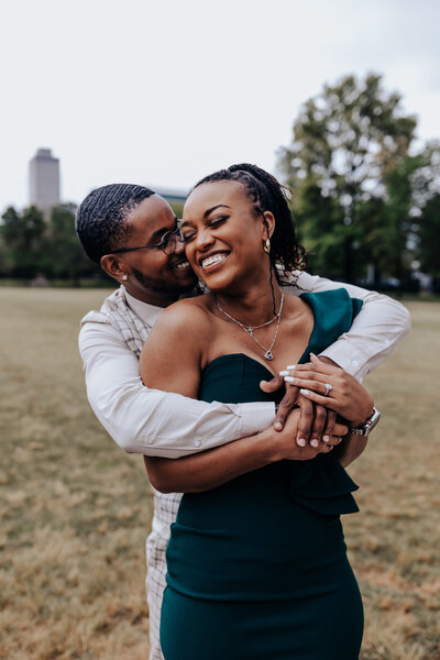 Nashville engagement photographer captures park engagement session where couple has their arms wrapped around each other during recent engagement