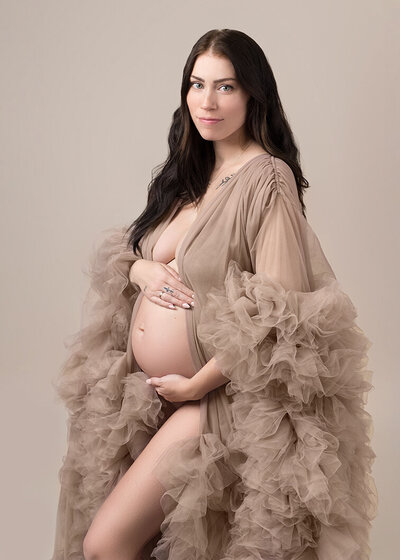 Fine art maternity portrait of beautiful dark haired woman captured by Laura King Photography