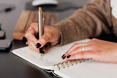 A woman writing in  journal. Showing one of the techniques you might learn in stress management counseling. Get additional tips from a stress management counselor Manhattan.
