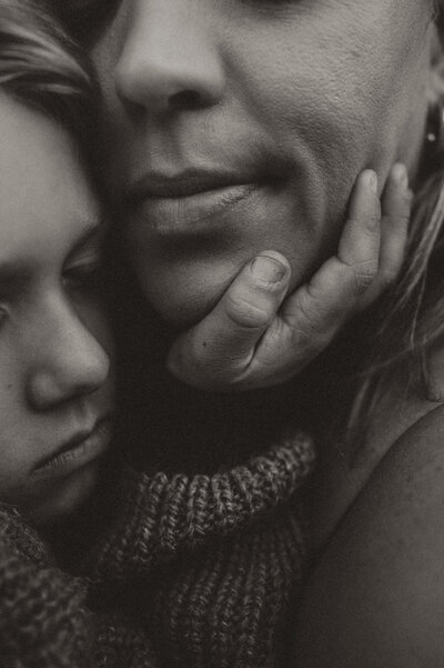 A gorgeous blonde woman wearing white undergarments on a bed of white. 