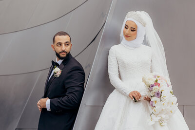 Middle eastern bride and groom taking couple photos at the walk dinsye concert hall in los angeles muslim bride