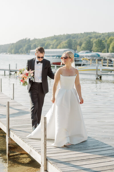 newlyweds walk on dock