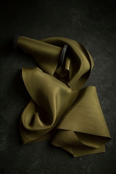 A rich olive green ribbon flat lay 