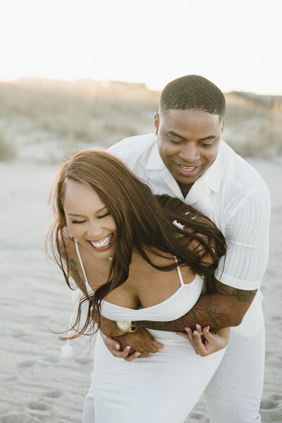 bride and groom on the beach at sunset