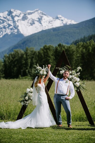 Newlyweds popping champagne bottle