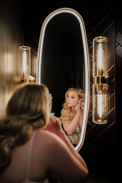 Bride gets ready in salon before Colorado elopement ceremony.