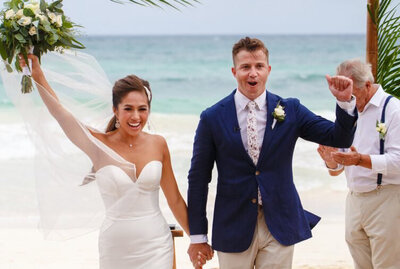 Bride Veronica and groom Massimo kiss as onlookers cheer during their destination wedding in Italy.