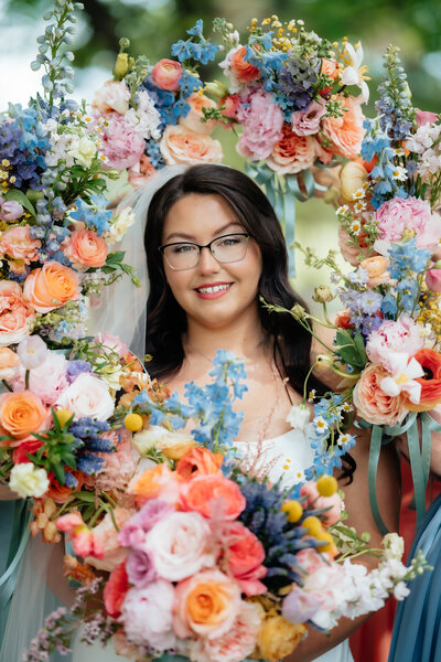 bride surrounded with bouquets and radiating with joy before walking down the aisle 