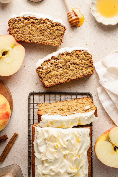 a gluten free zucchini loaf topped with frosting