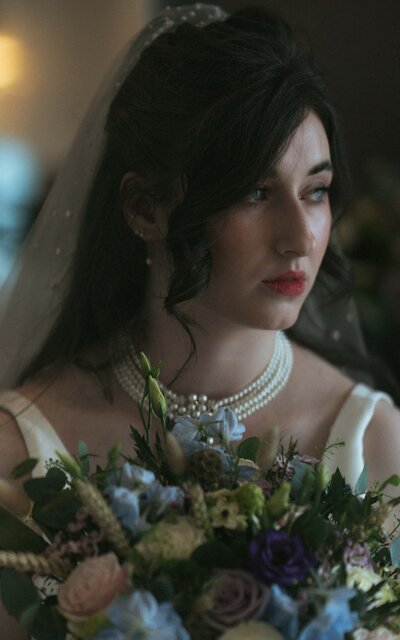 A stylish modern bride posing gracefully with a stunning bouquet, capturing her beauty and elegance on her wedding day