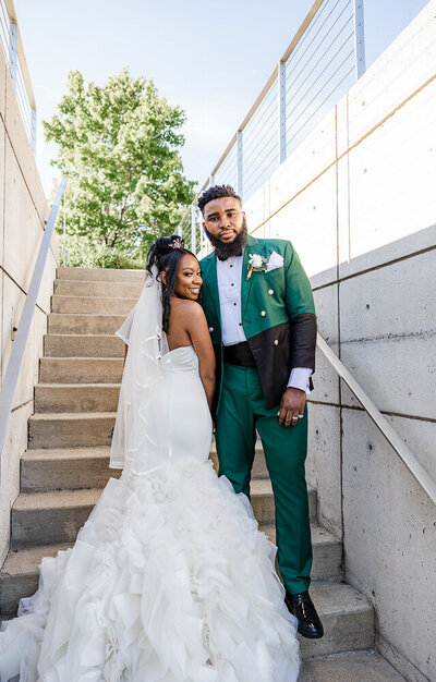 Stylish couple posing on the steps of wedding venue