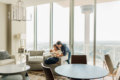 Professional maternity picture of a couple in gorgeous golden light, gazing down at her belly.