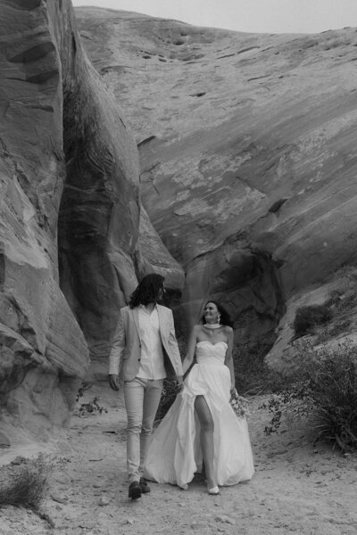 bride and groom smiling at each other as they explore southern utah's canyon country