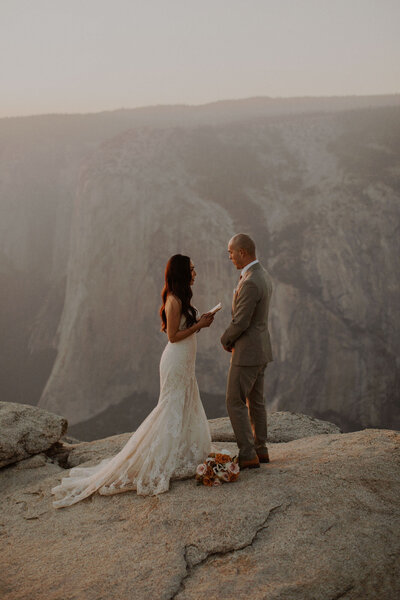 Bride and groom read vows in Yosemite