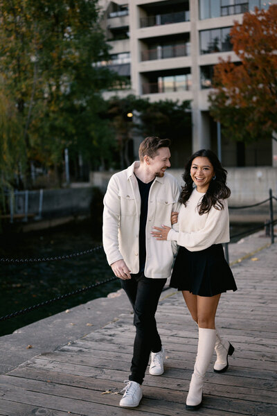 Engagement photo of couple walking at the Toronto Harbour 
