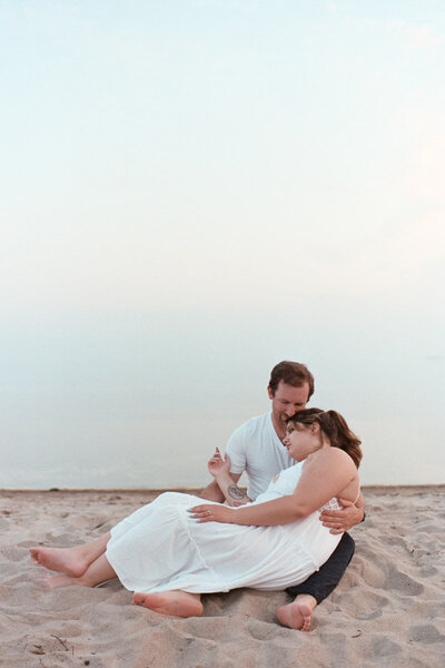 A couple sitting by the water documented by a Sudbury Documentary Photographer