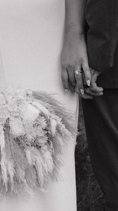 Bride and Groom showcasing bridal flowers and wedding rings